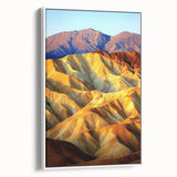 Framed canvas artwork depicting a vibrant desert landscape, showcasing rich earthy tones and intricate details, perfect for home decor. The white frame enhances the visual appeal, making it an eye-catching addition to any room.