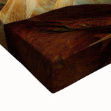 Close-up of a stretched canvas print depicting a vibrant desert landscape with warm hues of orange and yellow, showcasing intricate details and textures, perfect for enhancing home decor.