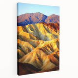 Stretched canvas artwork depicting a vibrant desert landscape, showcasing rich orange and yellow hues with textured brushstrokes, perfect for home decor.