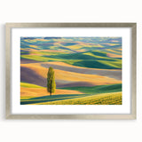 Framed landscape artwork featuring vibrant green fields and a serene blue sky, elegantly presented with a silver mat and frame, perfect for home decor.