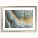 Textured abstract art print featuring close-up floral designs in soft pastel shades, framed in silver.