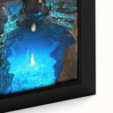Close-up view of a framed canvas depicting a vibrant landscape scene featuring intricate cave formations, showcasing rich colors and detailed textures, ideal for home decor.