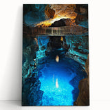 Stretched canvas artwork depicting a serene landscape with caves and natural rock formations, featuring earthy tones and intricate details, perfect for home decor.