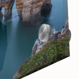 Close-up of an acrylic landscape artwork depicting colorful cliffs under a clear blue sky, showcasing vibrant hues and intricate details for a stunning visual impact.