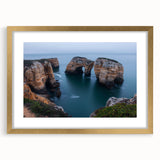 Framed landscape art print featuring dramatic cliffs and serene ocean views, with a stylish gold mat for enhanced elegance, ideal for home decor.