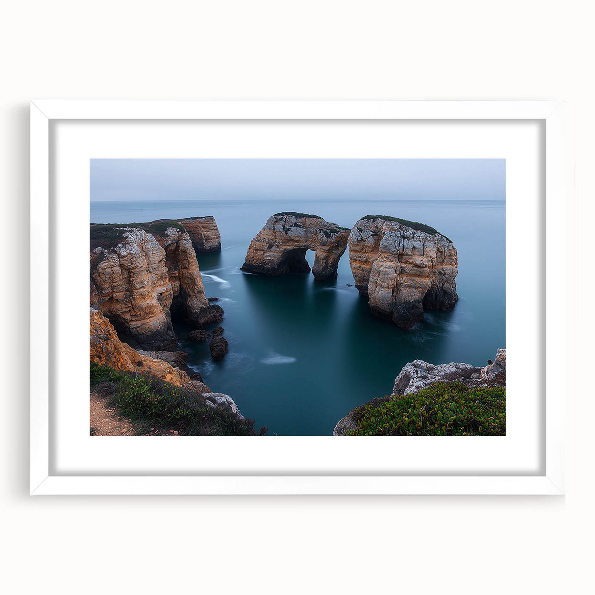Framed landscape artwork showcasing dramatic cliffs, surrounded by a white mat, perfect for home decor. Ideal for nature lovers seeking elegant wall art.