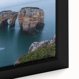 Close-up of a framed canvas artwork depicting a dramatic cliff landscape with vibrant colors and intricate details, ideal for enhancing living spaces or offices.