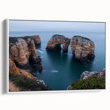 Framed canvas art showcasing a stunning landscape of rugged cliffs and vibrant colors, positioned on a white wall, ideal for home decor and nature enthusiasts.