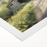 Art deco poster of an architecture-covered bridge in muted brown and beige tones on rolled canvas.