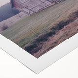 Rolled canvas showcasing a vibrant landscape barn design with rich colors and intricate details, securely packaged in a durable cardboard tube for easy transport and display.