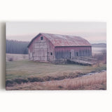 Stretched canvas artwork depicting a serene landscape featuring a rustic barn surrounded by lush greenery and vibrant blue skies, ideal for home decor.