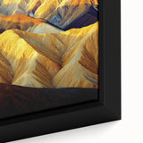 Close-up of a framed canvas showcasing a vibrant desert landscape with warm tones of orange and yellow, highlighting intricate details of the natural scenery. Ideal for home decor enthusiasts and art lovers.