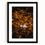 Abstract art print featuring a textured, colorful autumn landscape on a large canvas, framed in black.