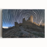 Stretched canvas artwork depicting a vibrant landscape with a majestic castle surrounded by lush greenery and a clear blue sky, ideal for home decor.