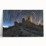 Stretched canvas artwork depicting a serene landscape with a majestic castle surrounded by lush greenery and a clear blue sky, perfect for home decor.