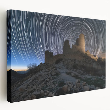 Stretched canvas artwork showcasing a picturesque landscape with a majestic castle nestled among lush greenery under a bright blue sky, perfect for home decor.