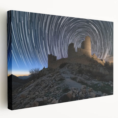Stretched canvas artwork showcasing a picturesque landscape with a majestic castle nestled among lush greenery under a bright blue sky, perfect for home decor.