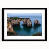Black-framed landscape artwork showcasing dramatic cliffs and vibrant skies, presented with a white mat for an elegant finish, ideal for home decor.