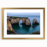 Elegant gold-framed landscape artwork depicting majestic cliffs, enhanced with a white mat for a refined look, perfect for home decor or office settings.