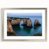 Framed landscape artwork featuring dramatic cliffs in a silver mat, showcasing vibrant colors and intricate details, perfect for enhancing modern home decor.