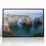 Framed acrylic artwork showcasing a stunning landscape of dramatic cliffs under a vibrant blue sky, designed to enhance modern decor with its sleek black frame.