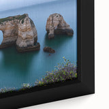 Close-up of a framed canvas artwork depicting a dramatic landscape of cliffs with vibrant colors and intricate details, perfect for home decor and art enthusiasts.