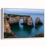Framed canvas art depicting a serene landscape with dramatic cliffs and lush greenery, showcasing a white frame that complements the artwork's natural beauty. Perfect for home decor enthusiasts seeking a touch of tranquility and elegance in their living spaces.