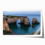 Stunning rolled print artwork depicting dramatic cliffs against a vibrant sunset, showcasing rich colors and intricate details, perfect for home decor.