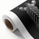 Rolled canvas showcasing vibrant animal illustrations in a modern tribal style, elegantly packaged in a protective cardboard tube, perfect for home decor.