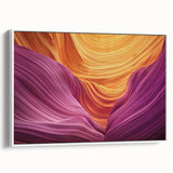 Framed canvas artwork depicting a stunning landscape of colorful canyons in vibrant hues of orange and red, set against a white border for a modern aesthetic.