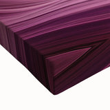 Close-up of a stretched canvas depicting a vibrant landscape of colorful canyons, showcasing intricate details and rich textures, ideal for home decor.