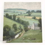 Stretched canvas wall art showcasing a serene countryside landscape, featuring lush green fields and a vibrant blue sky, perfect for home decor enhancement.