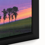 Framed canvas artwork showcasing a serene countryside landscape, featuring vibrant greens and a peaceful sky, ideal for home decor and nature enthusiasts.