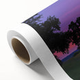 Rolled canvas artwork showcasing a tranquil countryside landscape with rolling hills and vibrant greenery, elegantly packaged in a protective cardboard tube.