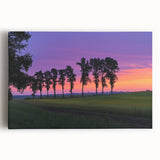 Stretched canvas artwork depicting a serene countryside landscape, featuring rolling hills and vibrant greenery under a clear blue sky, ideal for home decor.