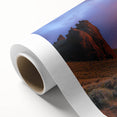 Desert landscape rolled canvas print showcasing vibrant hues of orange and yellow, wrapped securely in a protective cardboard tube, perfect for home decor.