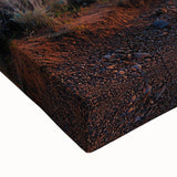 Close-up of a stretched canvas artwork depicting a vibrant desert landscape at sunset, showcasing rich orange and purple hues, ideal for modern home decor.