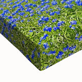 Close-up of a vibrant stretched canvas artwork depicting a serene landscape with lush green fields under a clear blue sky, perfect for home decor.