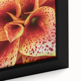 Close-up of black wall art featuring vibrant, textured floral designs on a framed canvas, ideal for living room decor.