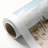 Art deco poster featuring a summery beach scene on rolled canvas, with pastel blue and sand tones.