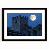 Elegant black-framed landscape artwork showcasing a majestic castle surrounded by lush greenery, with a white mat for a polished finish, ideal for home decor.