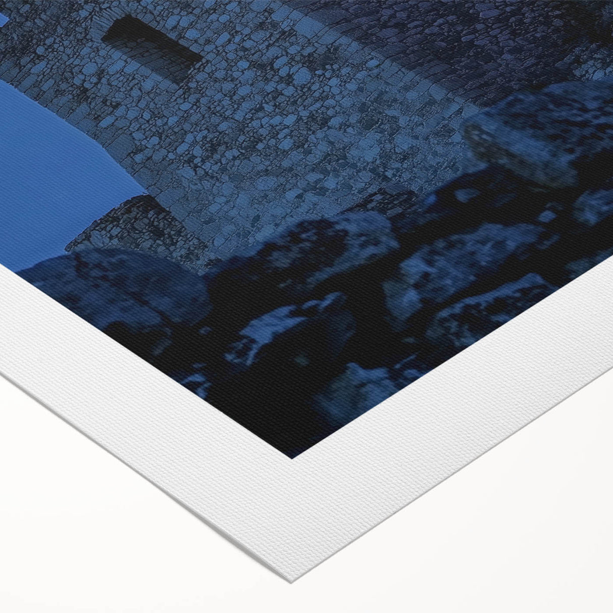 Rolled canvas artwork depicting a picturesque landscape with a majestic castle surrounded by vibrant greenery and a clear blue sky, ideal for home decor.