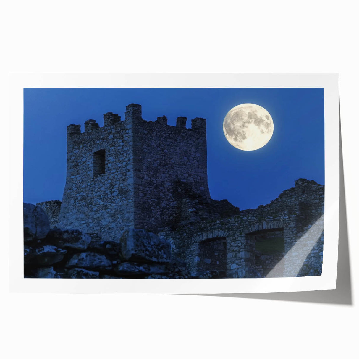 Rolled print showcasing a vibrant landscape featuring a majestic castle surrounded by lush greenery and a clear blue sky, elegantly packaged for easy display.