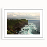 White-framed landscape artwork depicting dramatic cliffs against a vibrant sky, elegantly matted for a polished presentation, ideal for modern home decor.