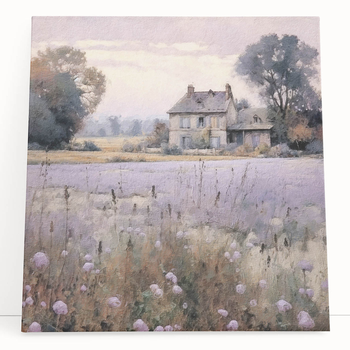 Stretched canvas wall art showcasing a serene countryside landscape with lush greenery and a vibrant blue sky, elegantly leaning against a wall for a rustic decor touch.