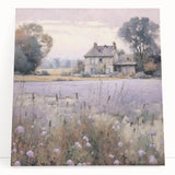 Stretched canvas wall art showcasing a serene countryside landscape with lush greenery and a vibrant blue sky, elegantly leaning against a wall for a rustic decor touch.