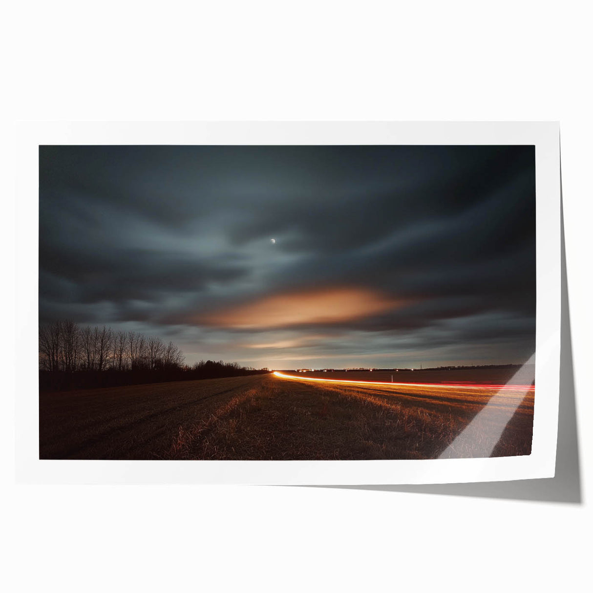 Landscape print of a serene countryside scene, showcasing rolling hills, vibrant green fields, and a clear blue sky, rolled and ready for framing.