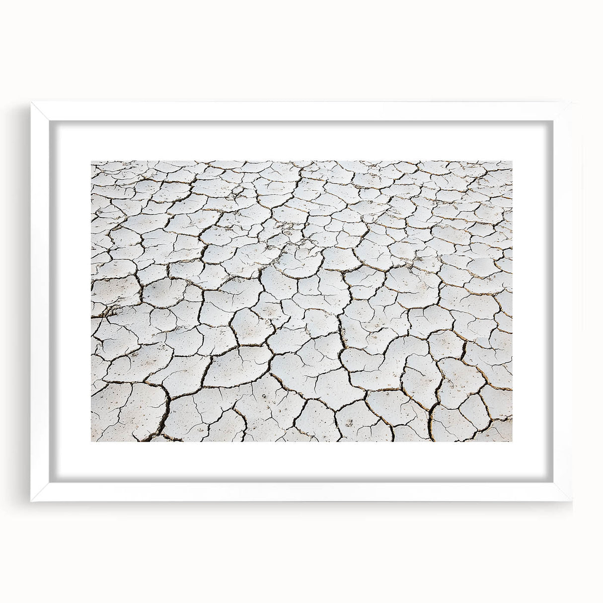Framed landscape artwork depicting a vibrant desert scene with earthy tones and a white mat, ideal for enhancing home decor and adding warmth to any space.