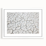 Framed landscape artwork depicting a vibrant desert scene with earthy tones and a white mat, ideal for enhancing home decor and adding warmth to any space.