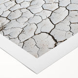 Desert landscape rolled canvas artwork displaying vibrant orange and yellow hues, showcasing an expansive sandy terrain under a clear blue sky, perfect for home decor.